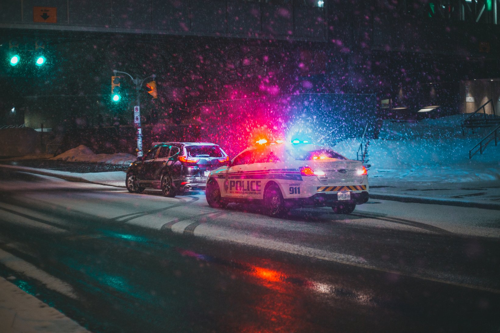 Police Car and a SUV parked on Roadside